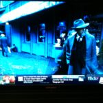 Watching a Samsung Smart TV with options at the bottom