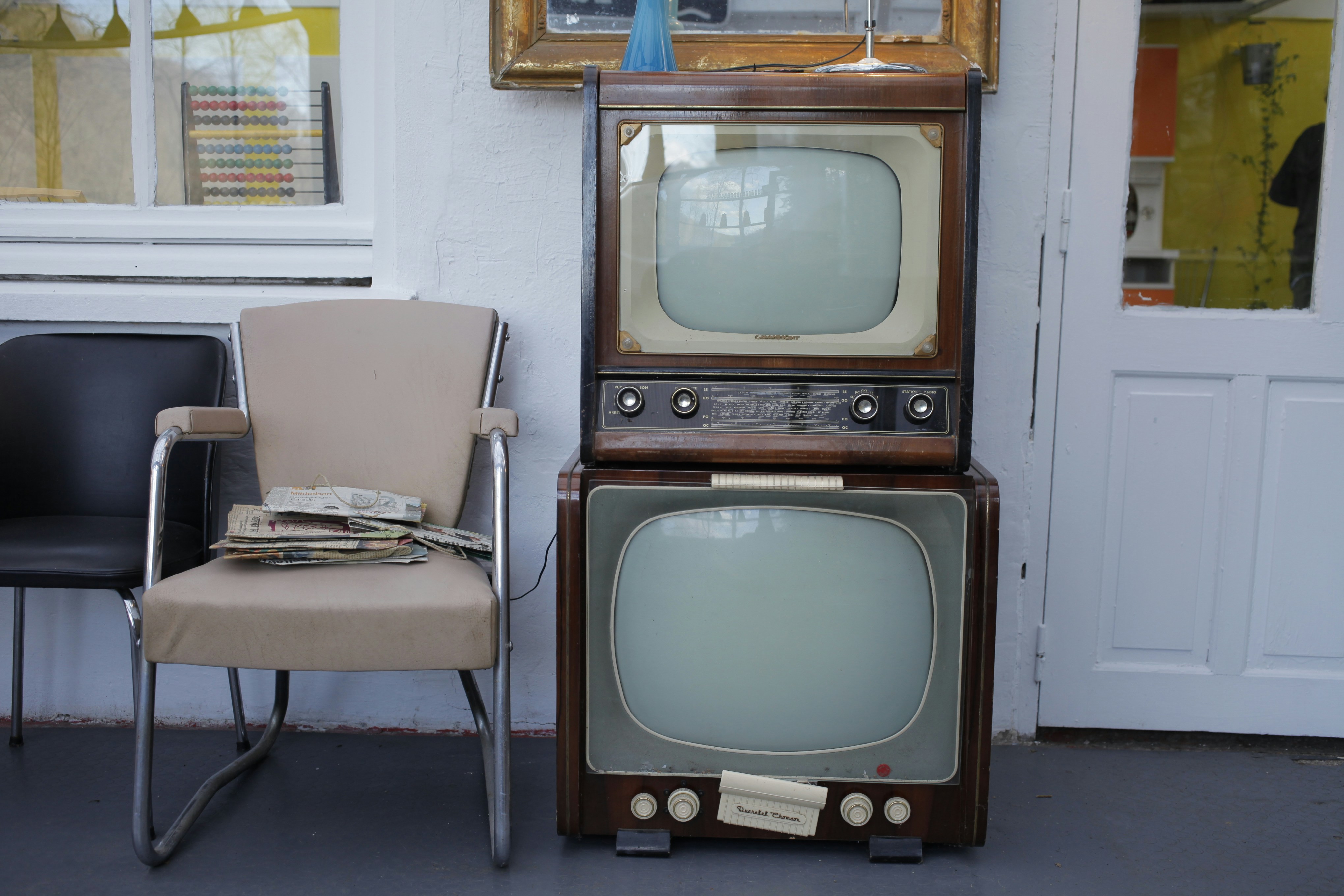 a chair and a television sitting next to each other