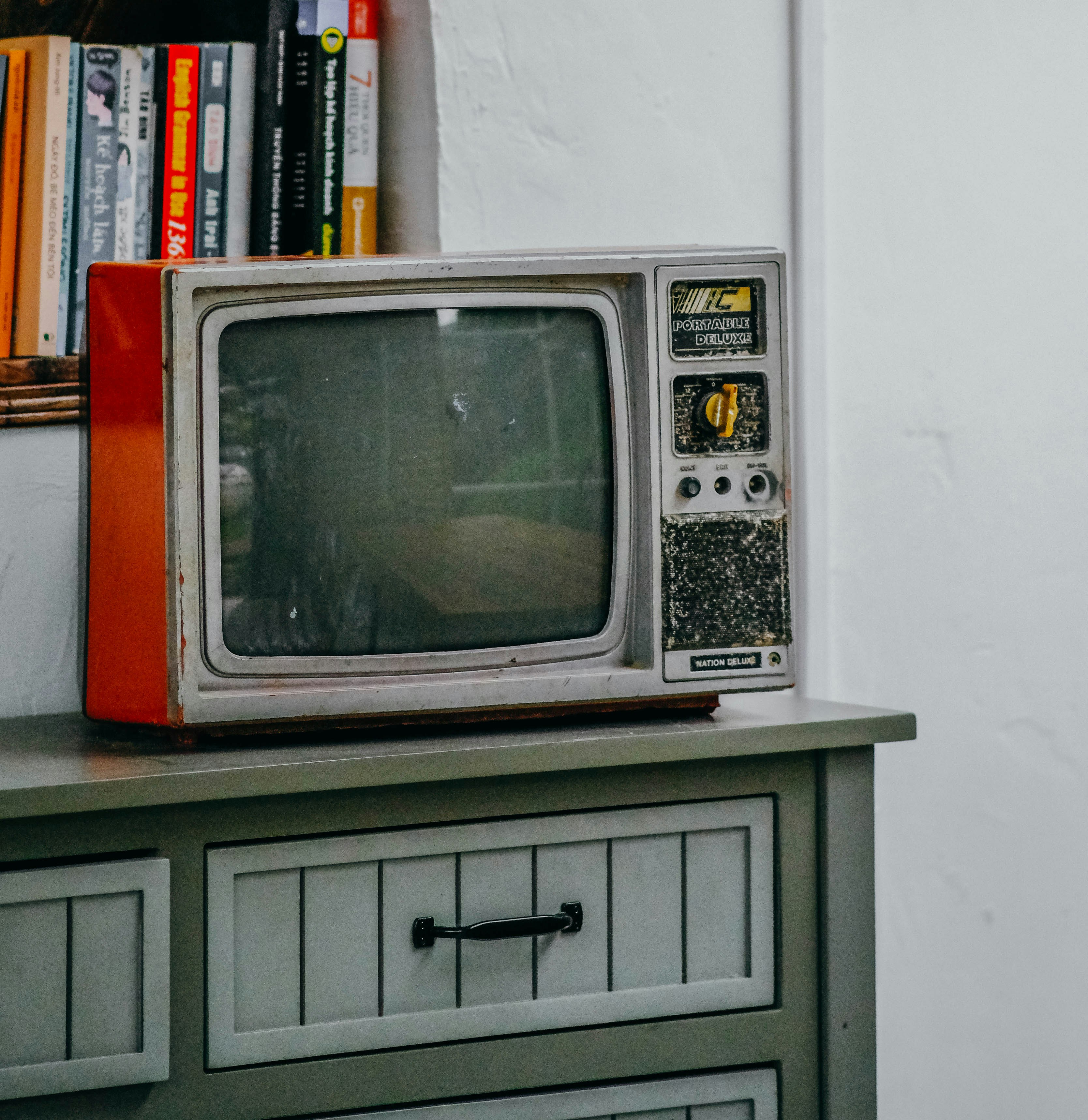 an old television sitting on top of a dresser