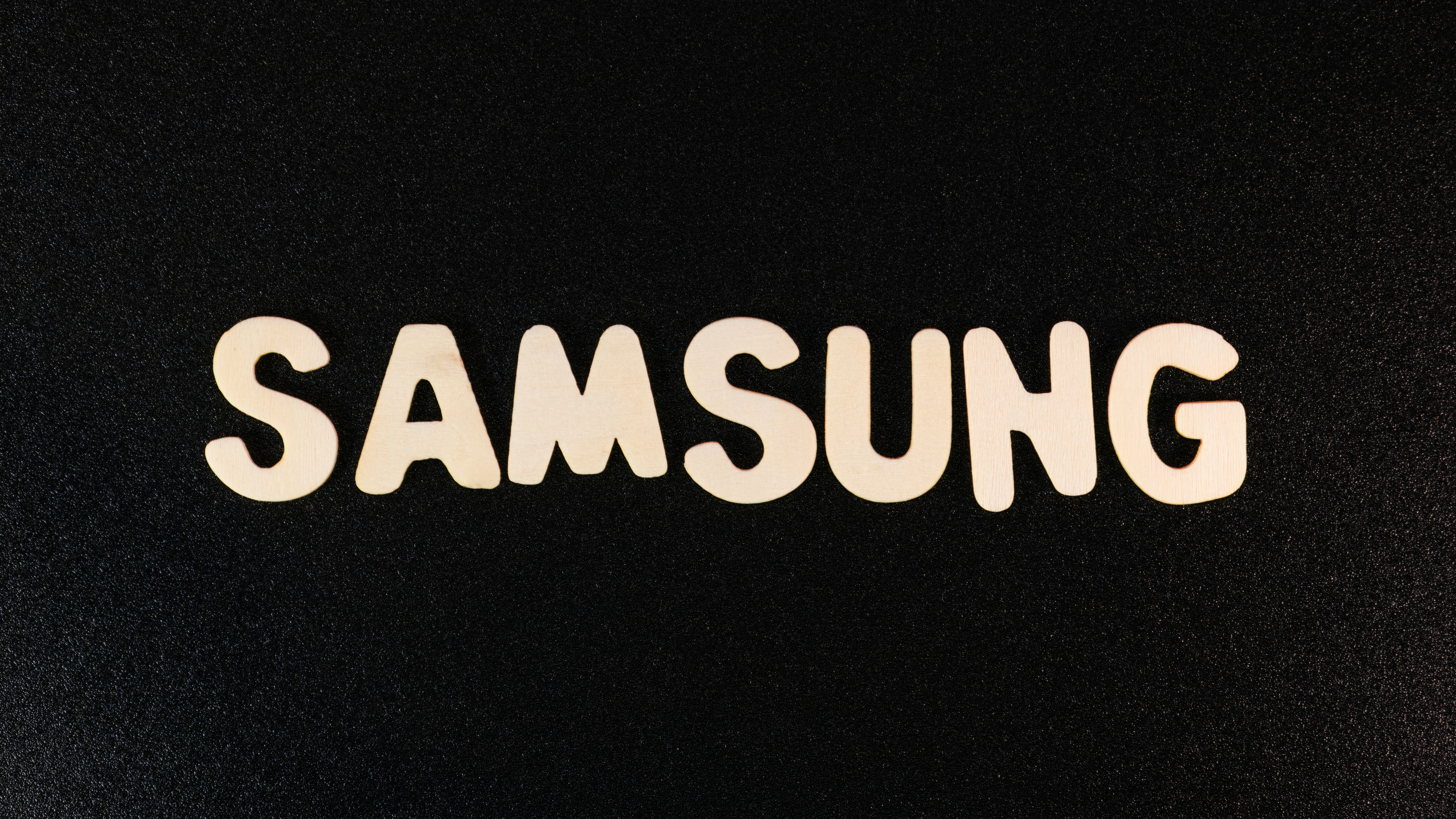a close up of a samsung logo on a black surface
