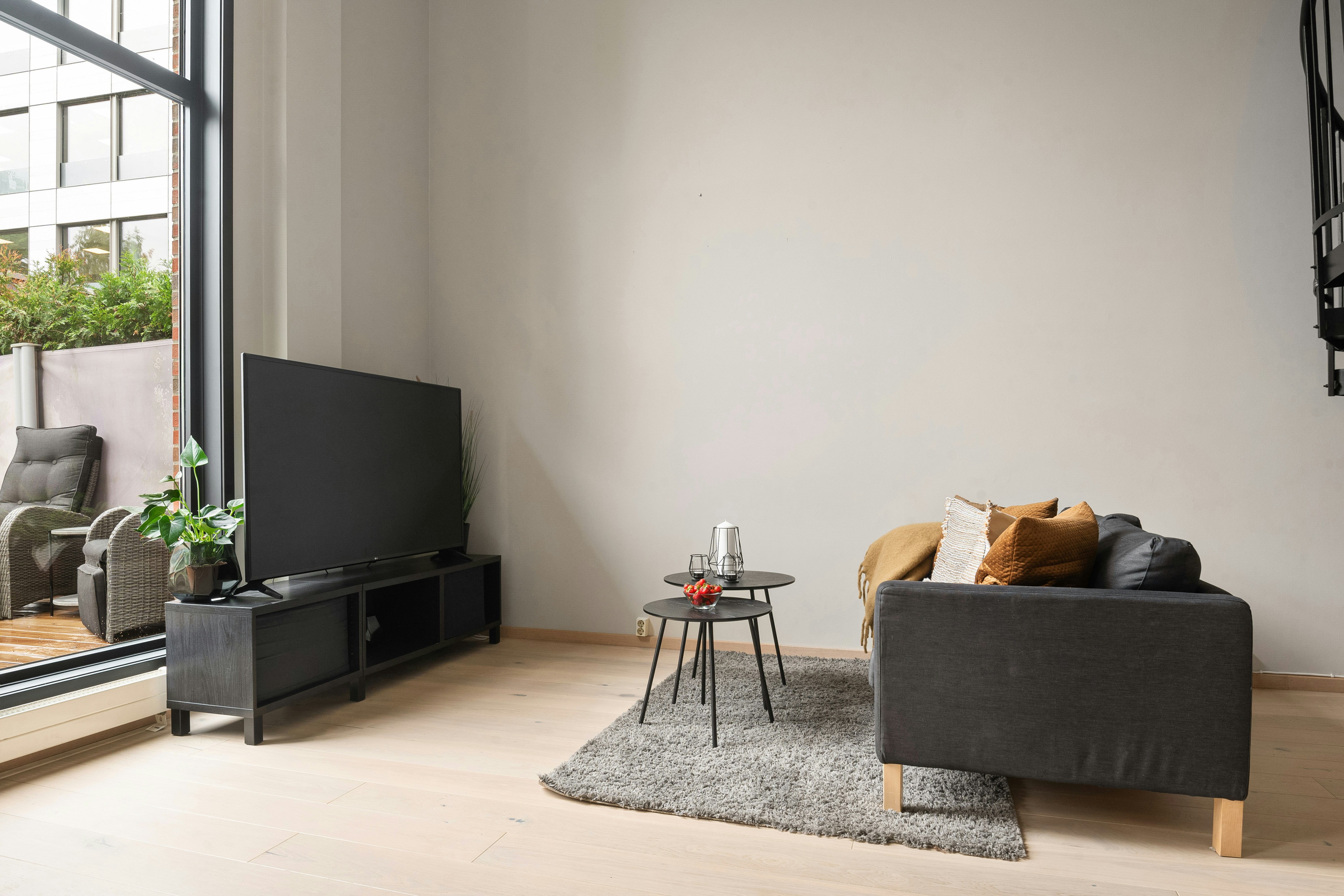 A living room filled with furniture and a flat screen TV