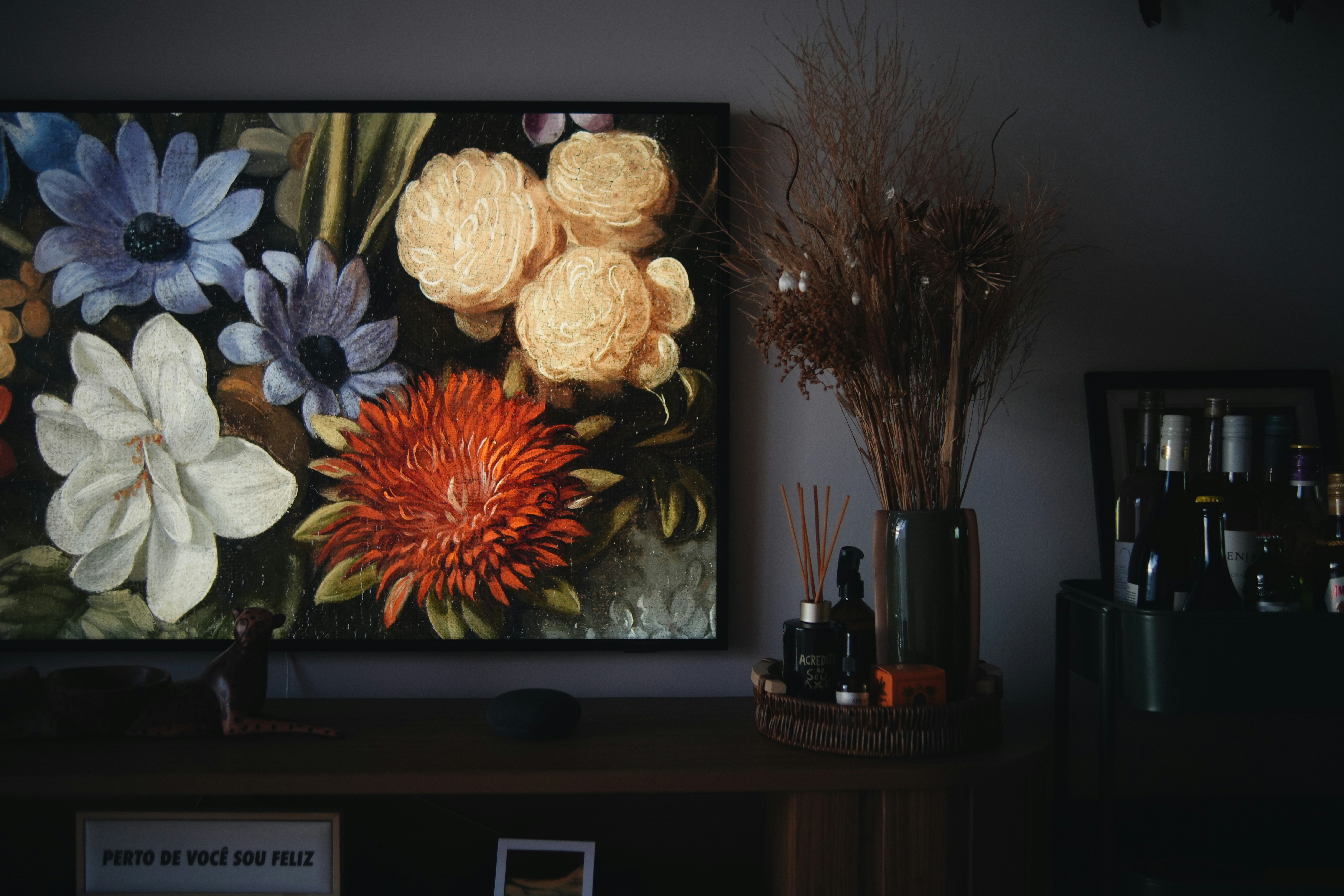 A painting of flowers on a wall in a living room