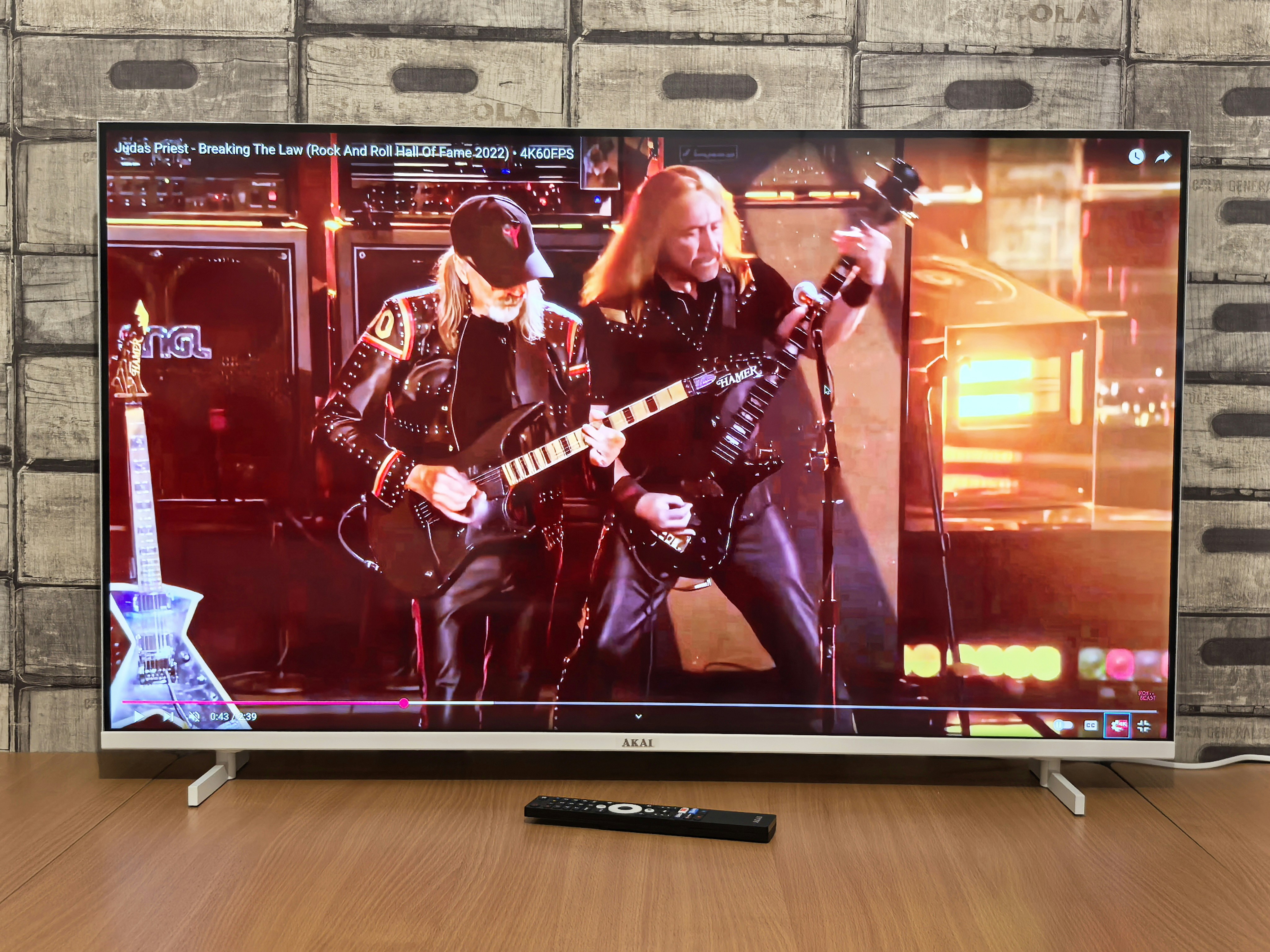 Two guitarists playing on a stage with bright stage lights