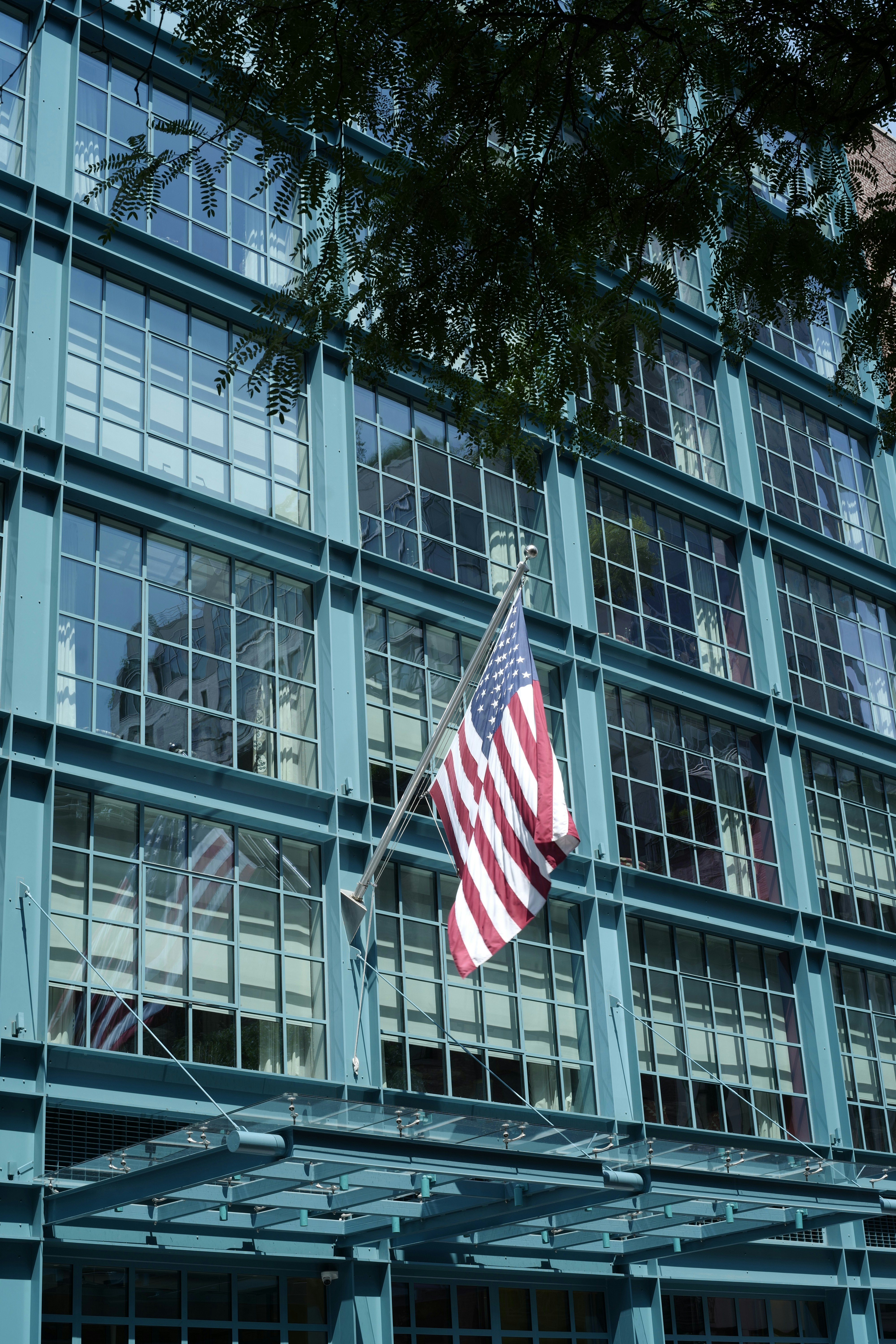 American flag on a teal building facade.