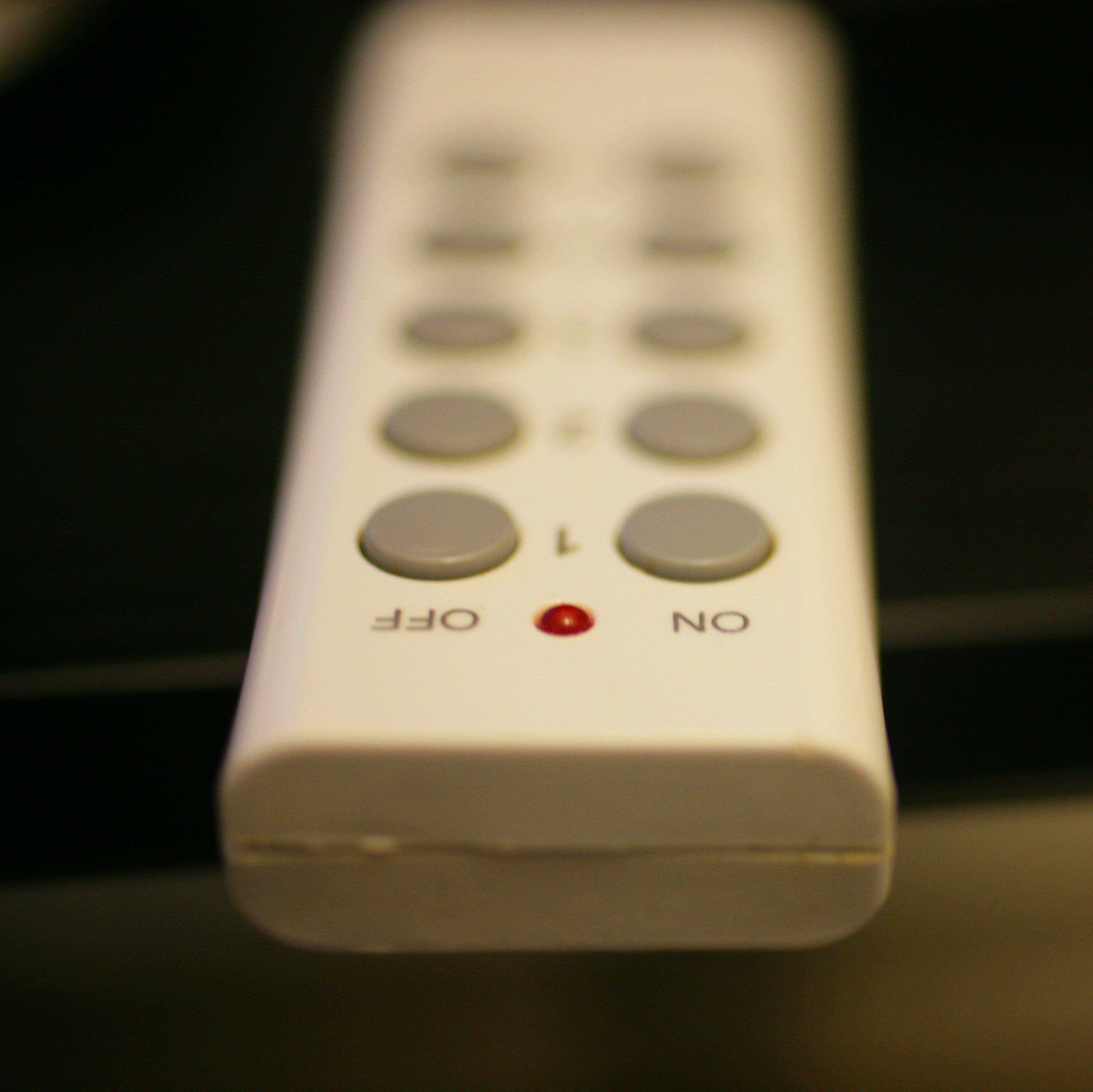 Remote control with buttons labeled 