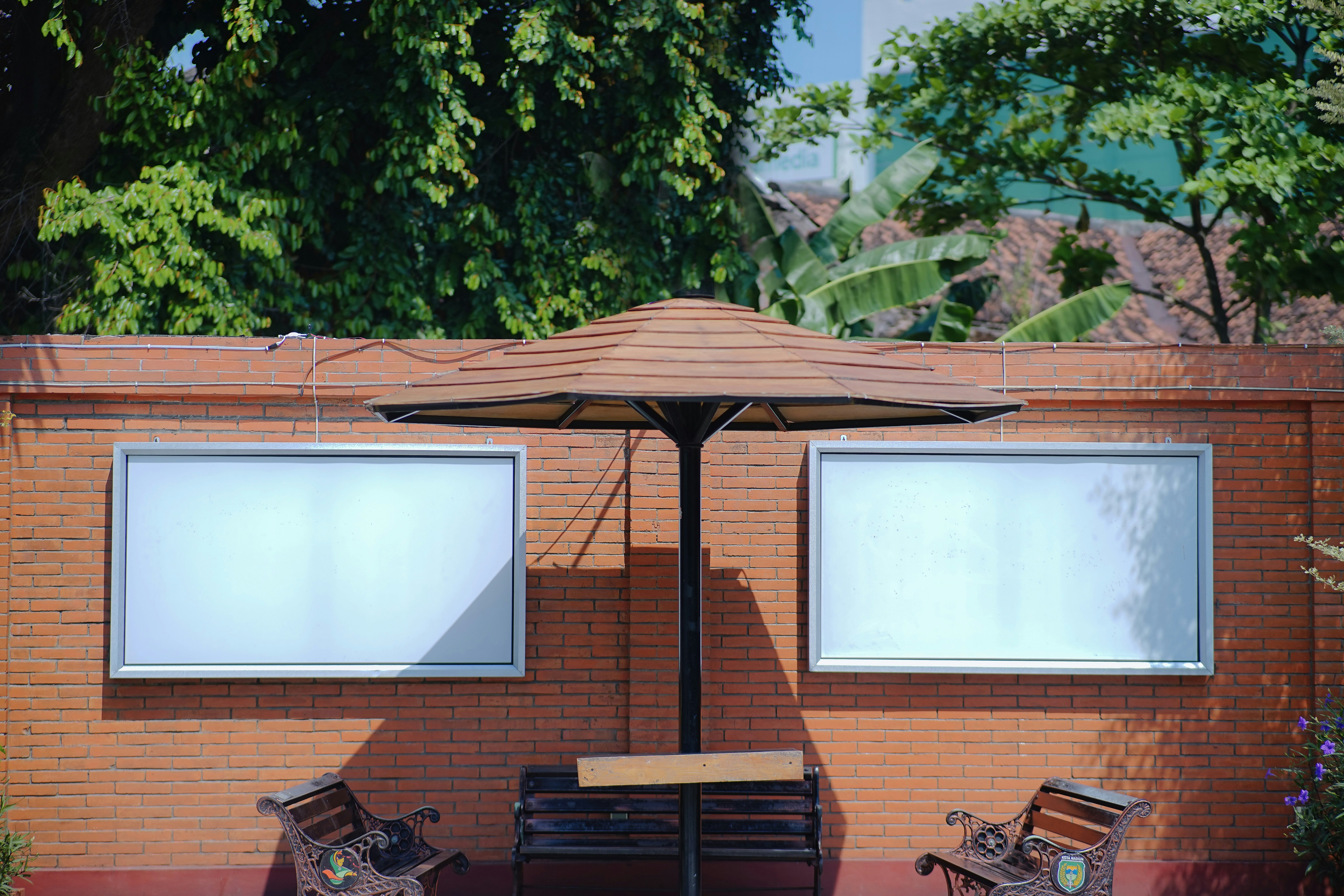 A couple of benches sitting under an umbrella