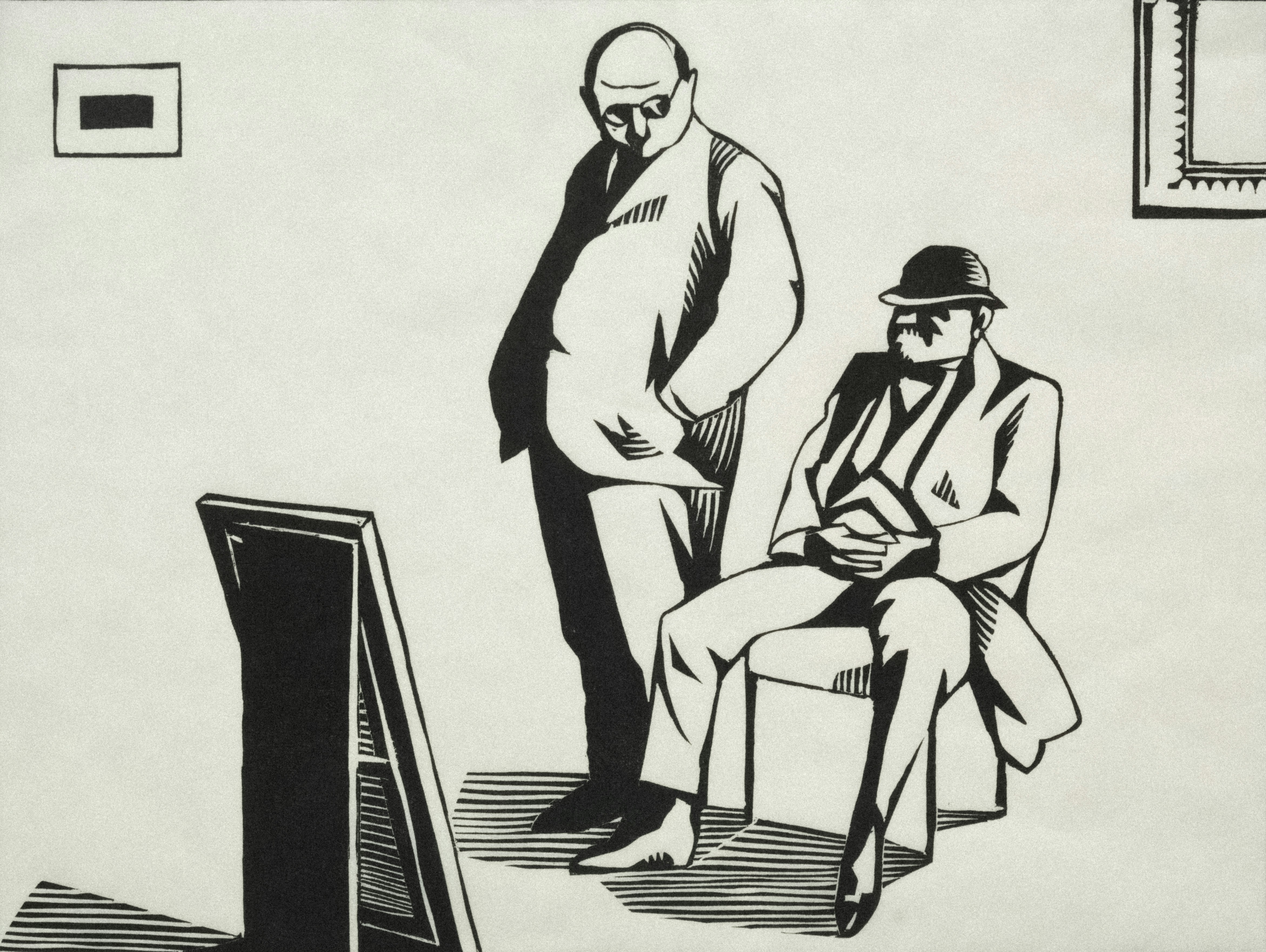Two men observe a framed artwork in a room.