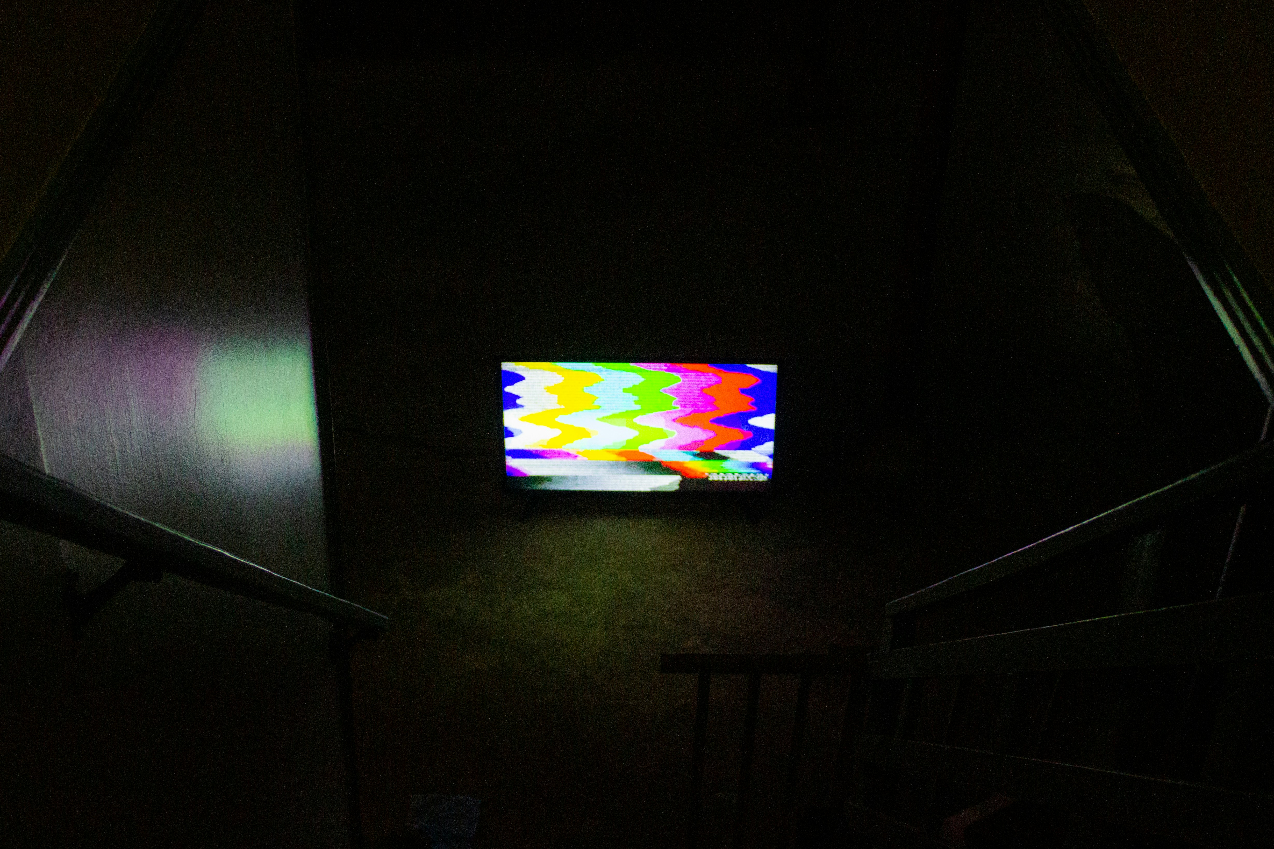 black flat screen tv turned on displaying soccer game