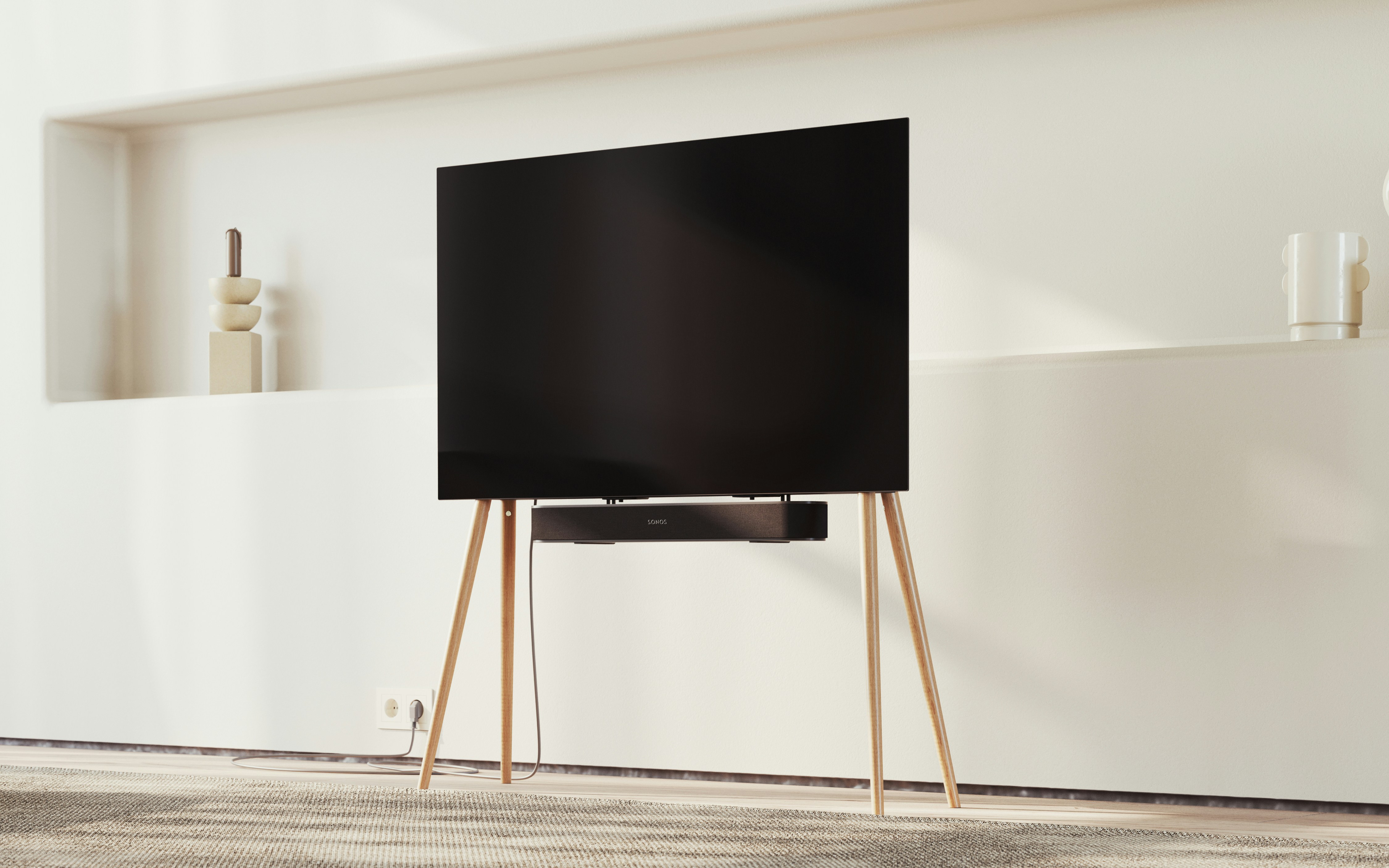 a flat screen tv sitting on top of a wooden stand