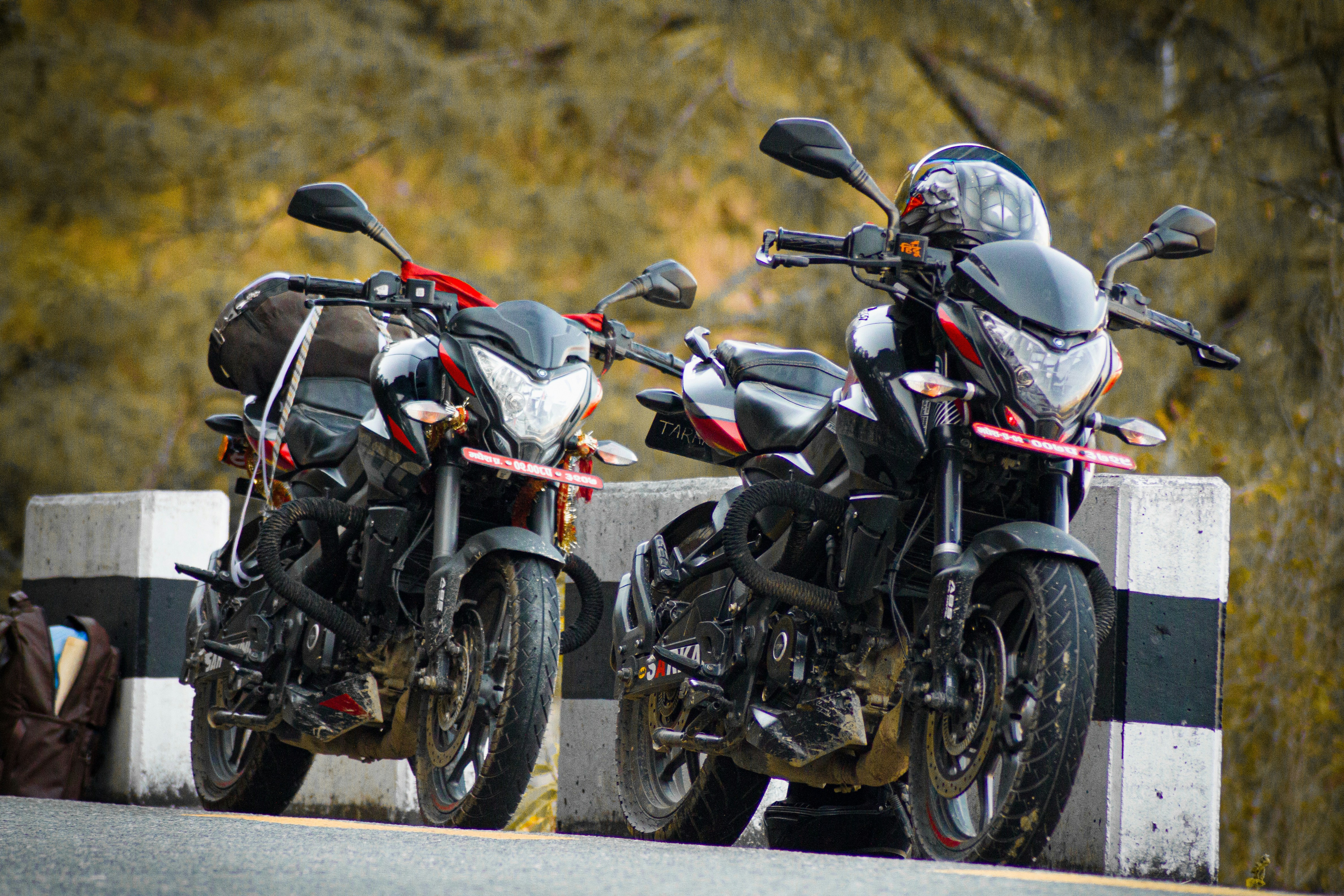 Two motorcycles parked next to each other on a road
