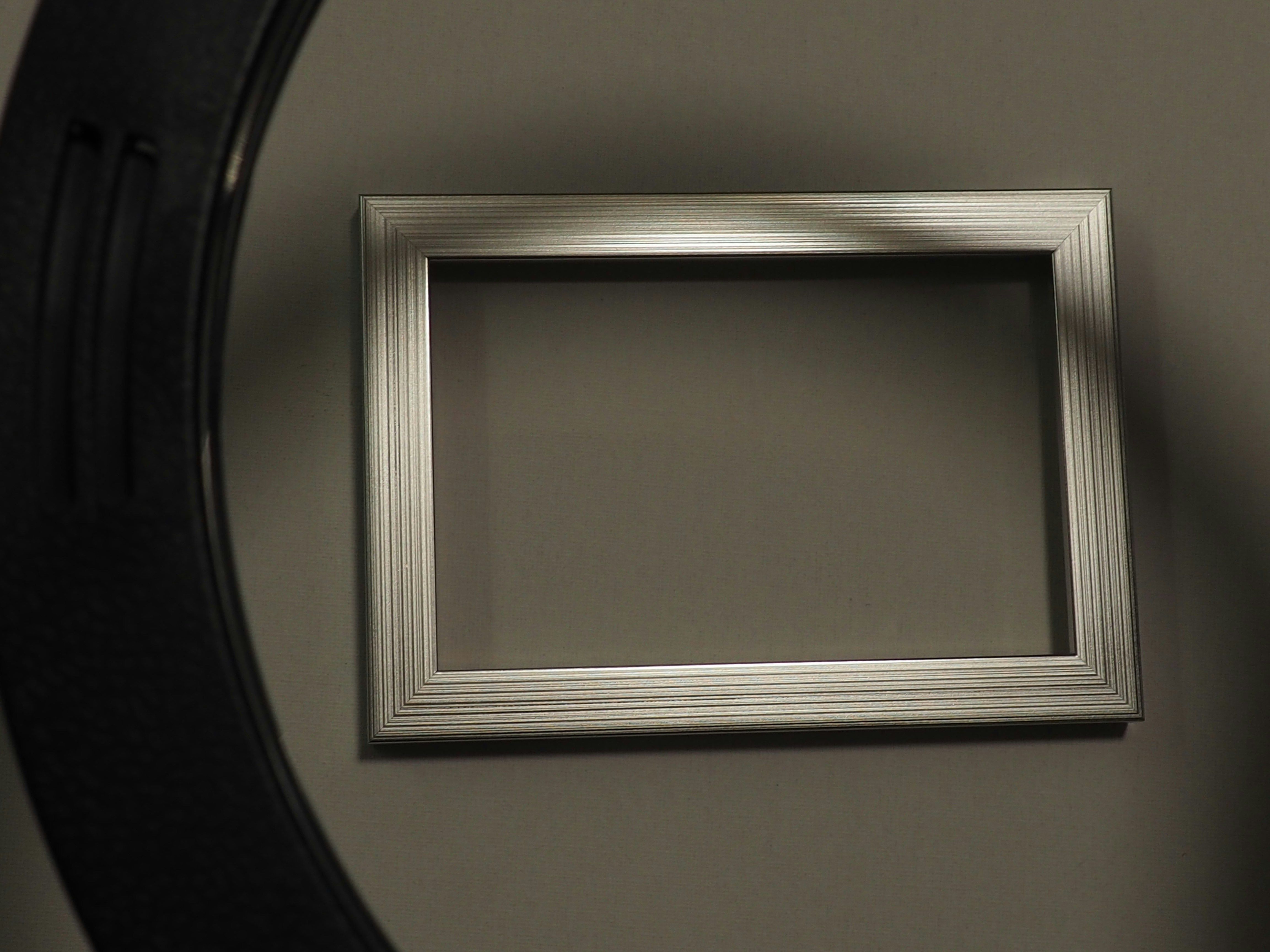 🏁 Conclusion by TV Brands Empty silver picture frame on a gray background.