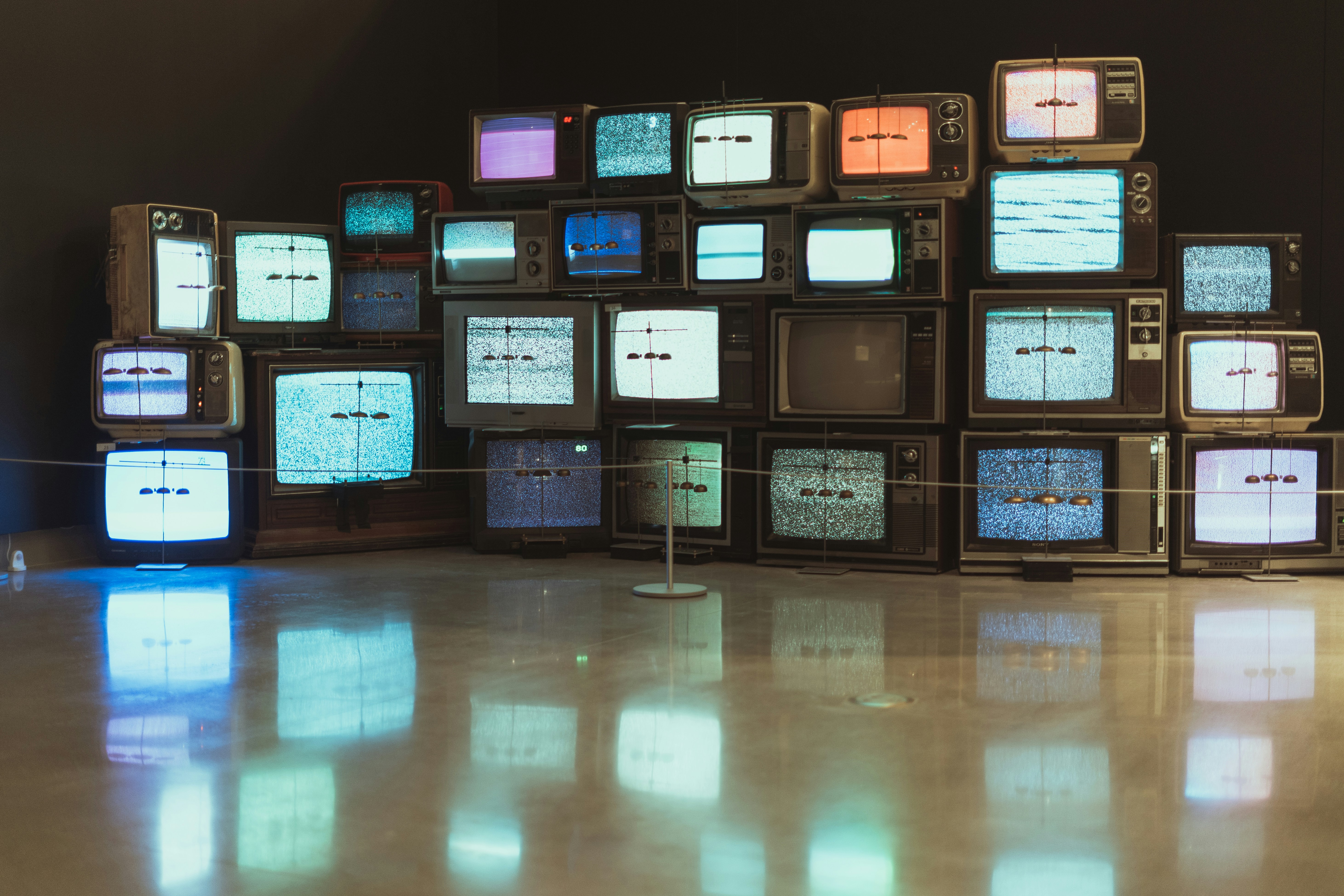 Ottawa Art Gallery (OAC) by TV Brands black plastic frame on brown wooden floor