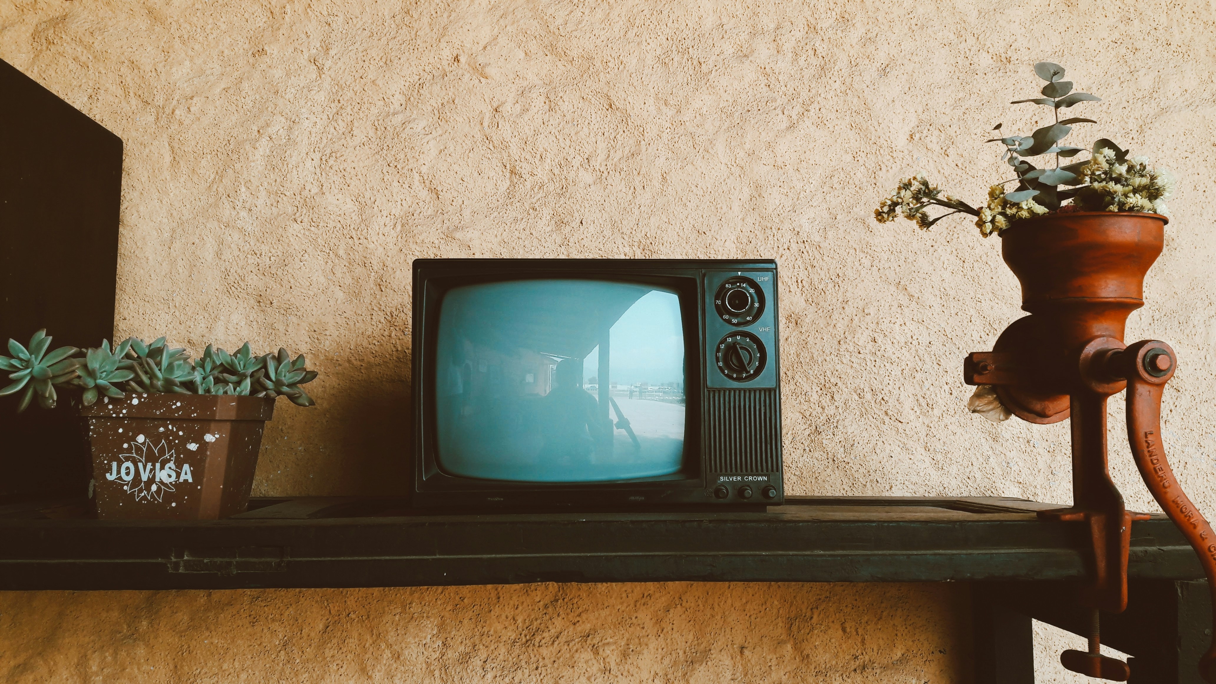 📜 The Rise of the Red Dragon: A Brief History of TCL by TV Brands black crt tv on black wooden table