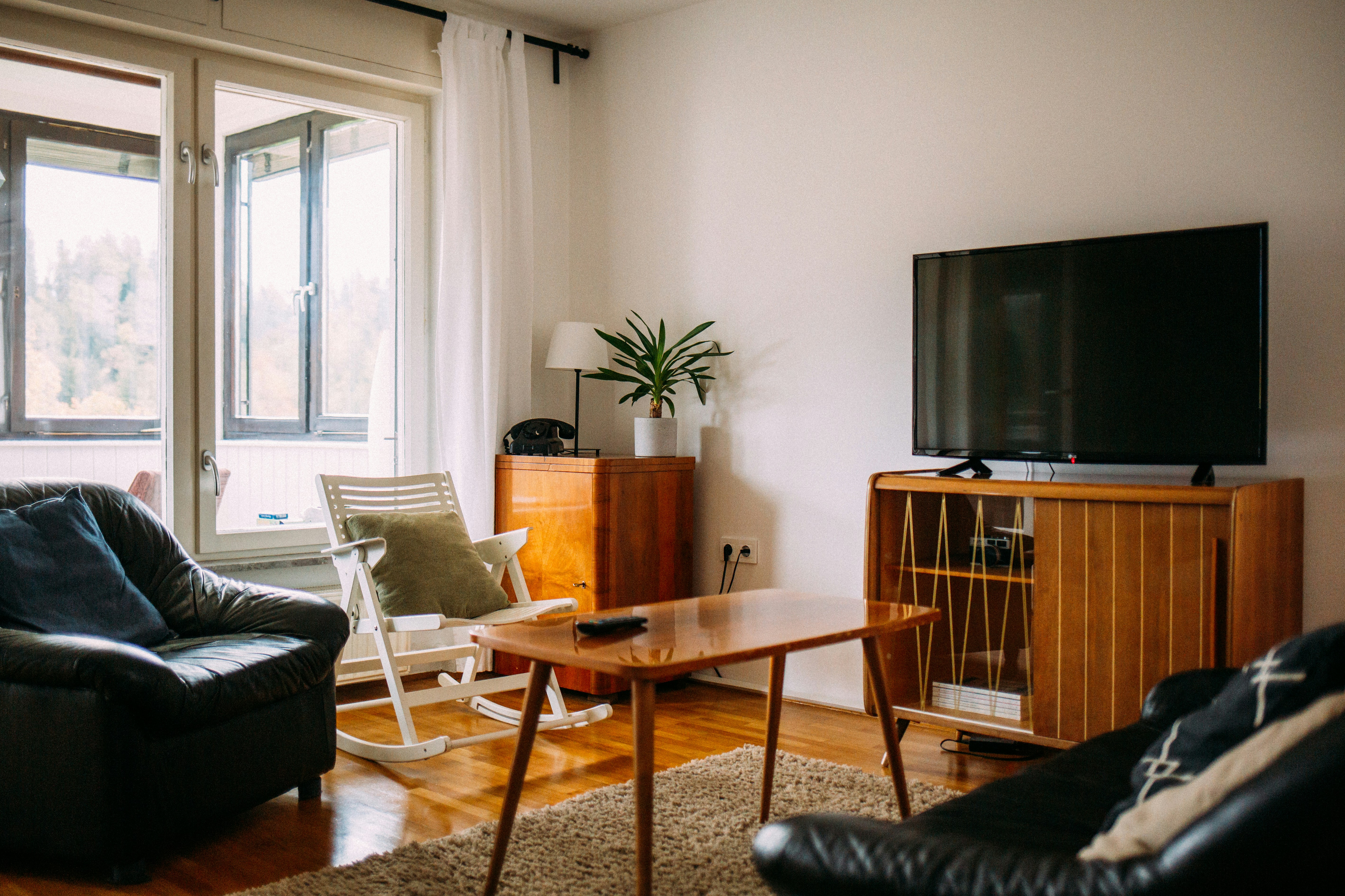 Apartment by TV Brands black flat screen tv on brown wooden tv rack