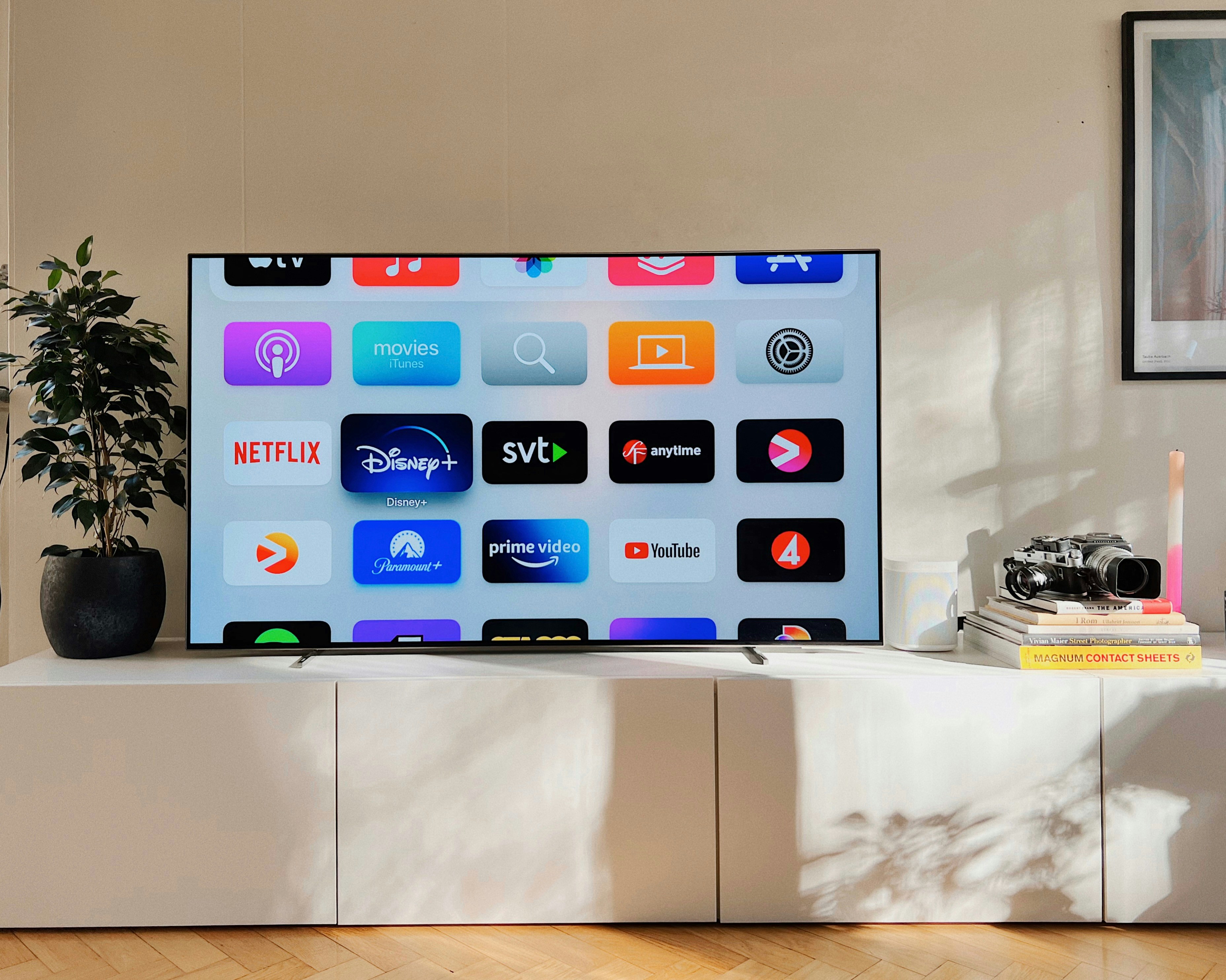 ❓ FAQ by TV Brands a flat screen tv sitting on top of a white cabinet