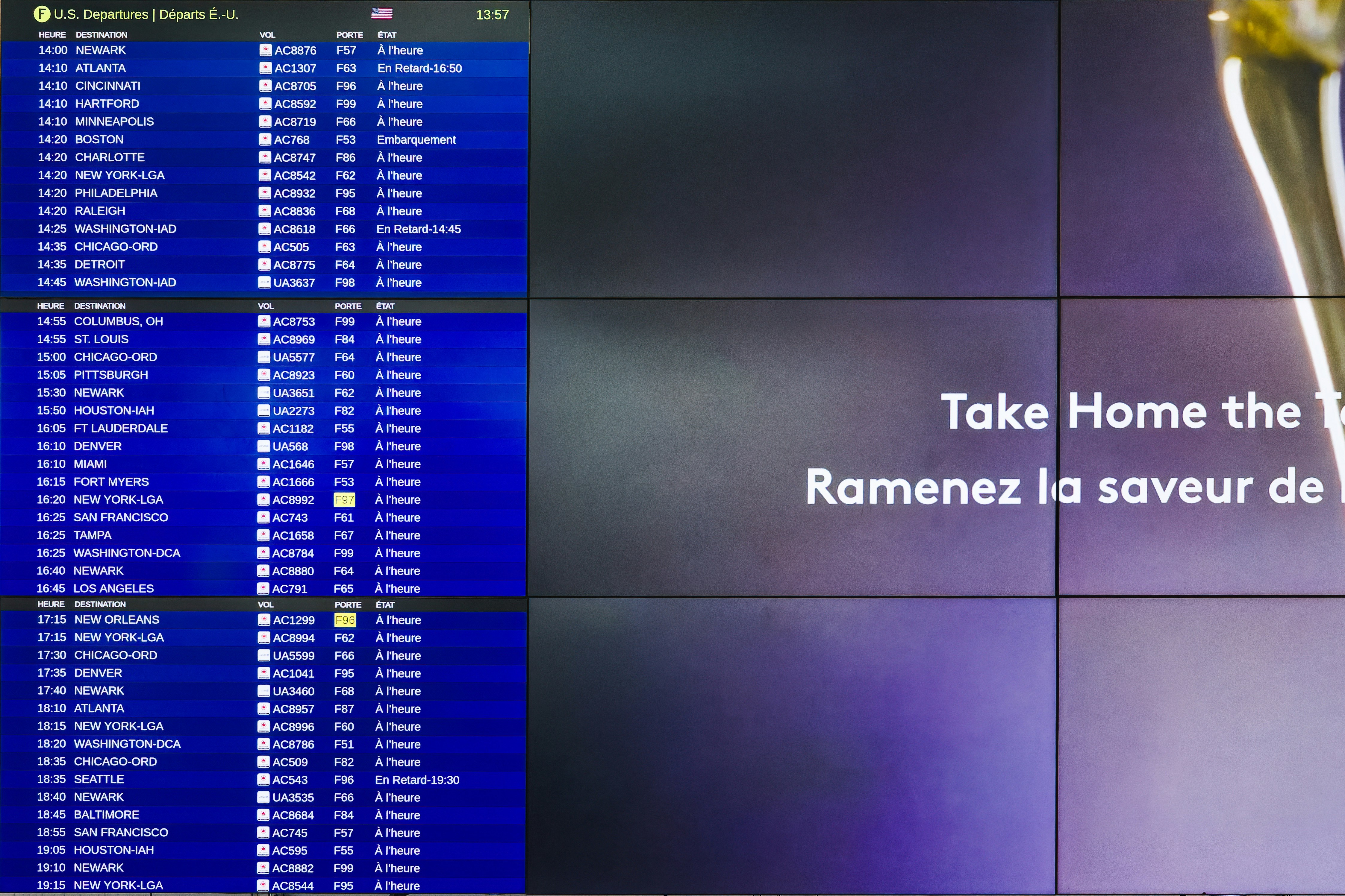 Airport Departure Board With Take Home the Taste Advertisement - A close-up shot of an airport departure board showing various flight times and destinations with an advertisement for Take Home the Taste with a French translation below it. The advertisement is partially by TV Brands a computer screen with a bunch of text on it