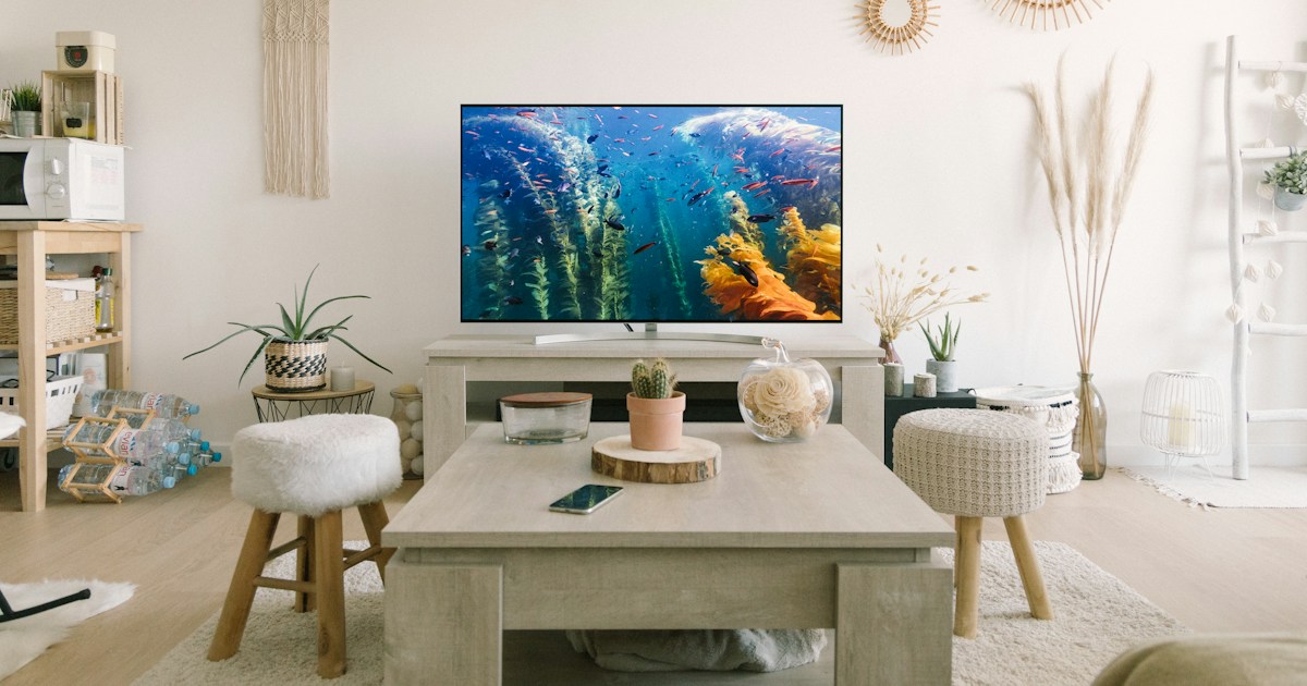 How do I choose the best TV brand for my budget and viewing needs? by TV Brands black flat screen tv turned on near white wooden table